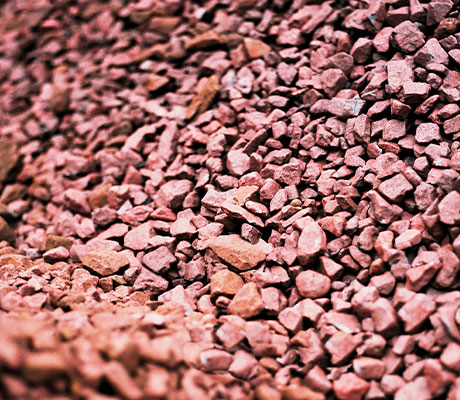 Close-up image of a pile of reddish ore