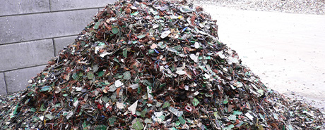 Large pile of unprocessed recycling material