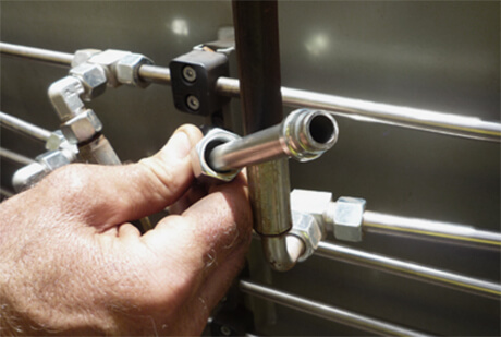 Close-up image of person attaching a spare part to a plant