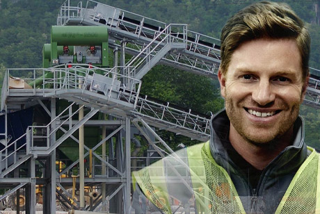 Friendly gentleman in front of wet processing plant